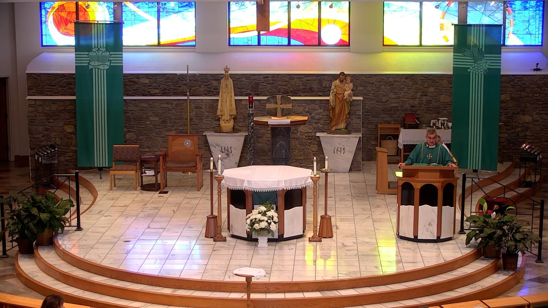 Father Pete celebrating mass in the main church at the ambo