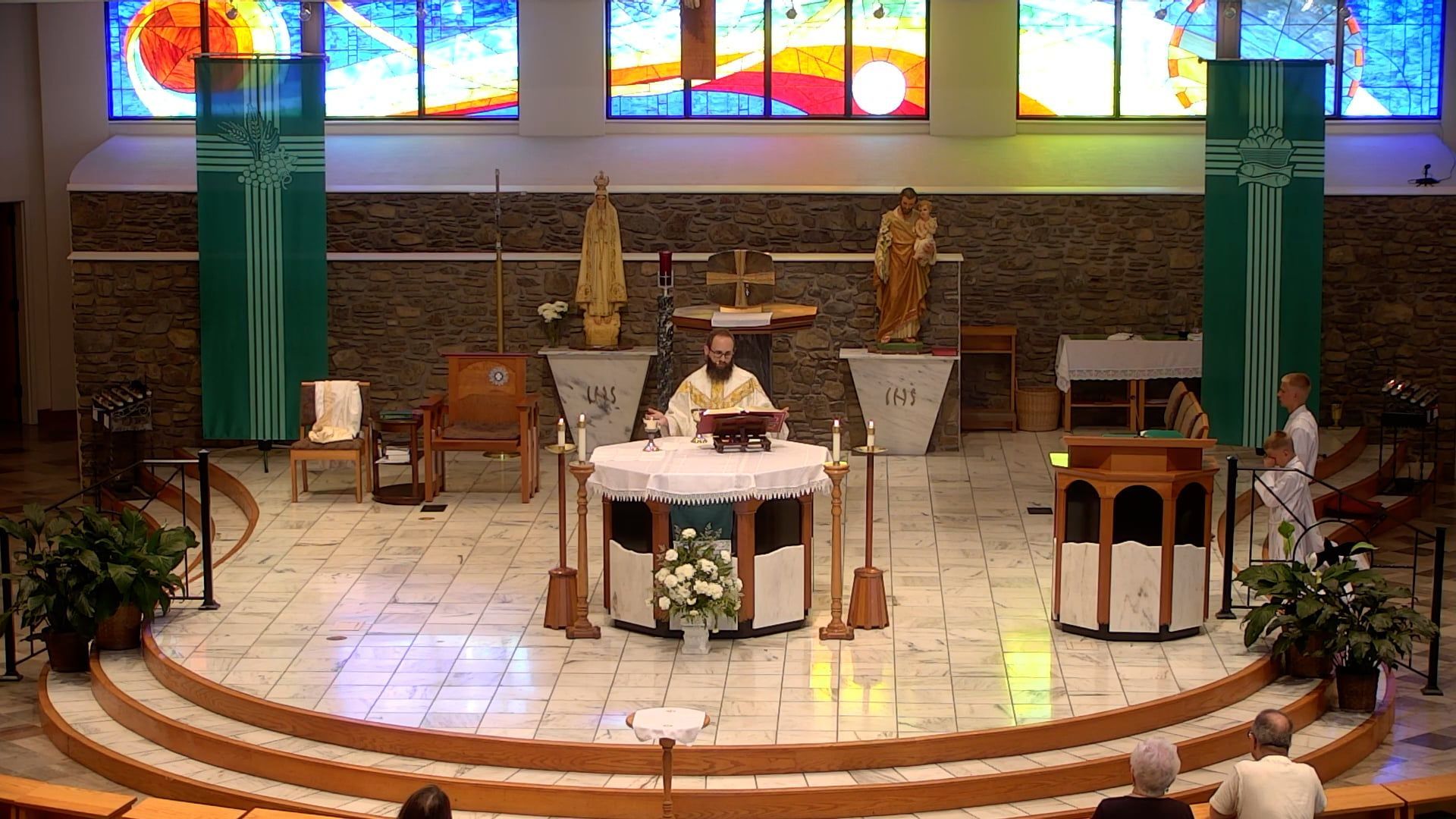 Father Joe celebrating mass in the main church at the altar. 