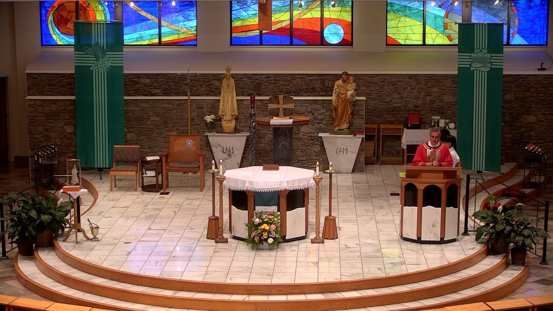 Father Pete at the altar in the main church  celebrating mass. 