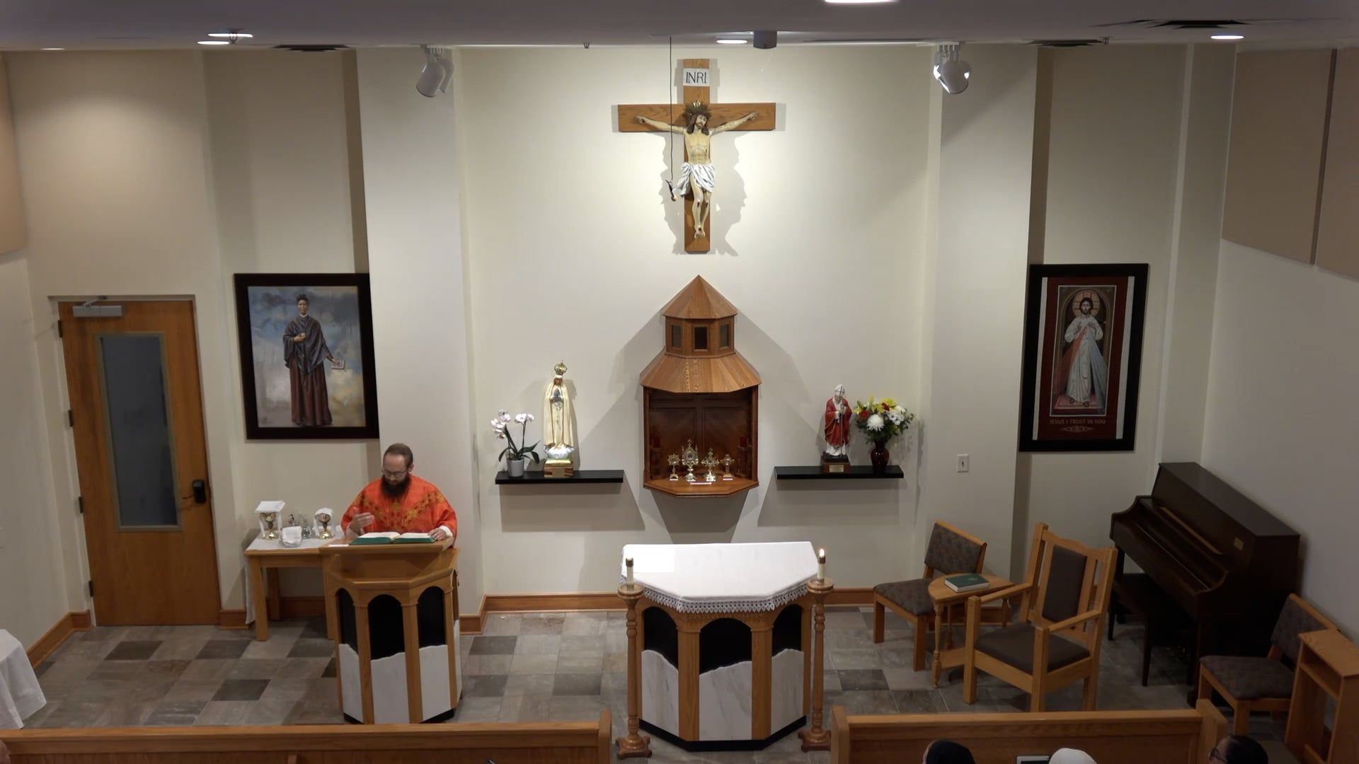 Fr. Joe standing at the amabo in the chapel. 