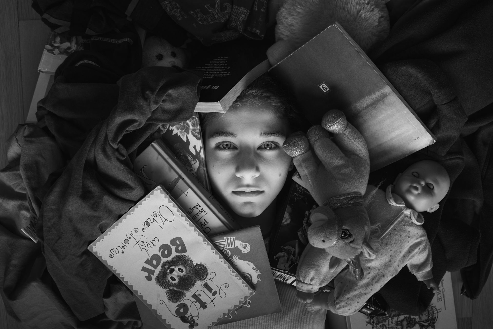 A person sitting in a cluttered room, looking overwhelmed

