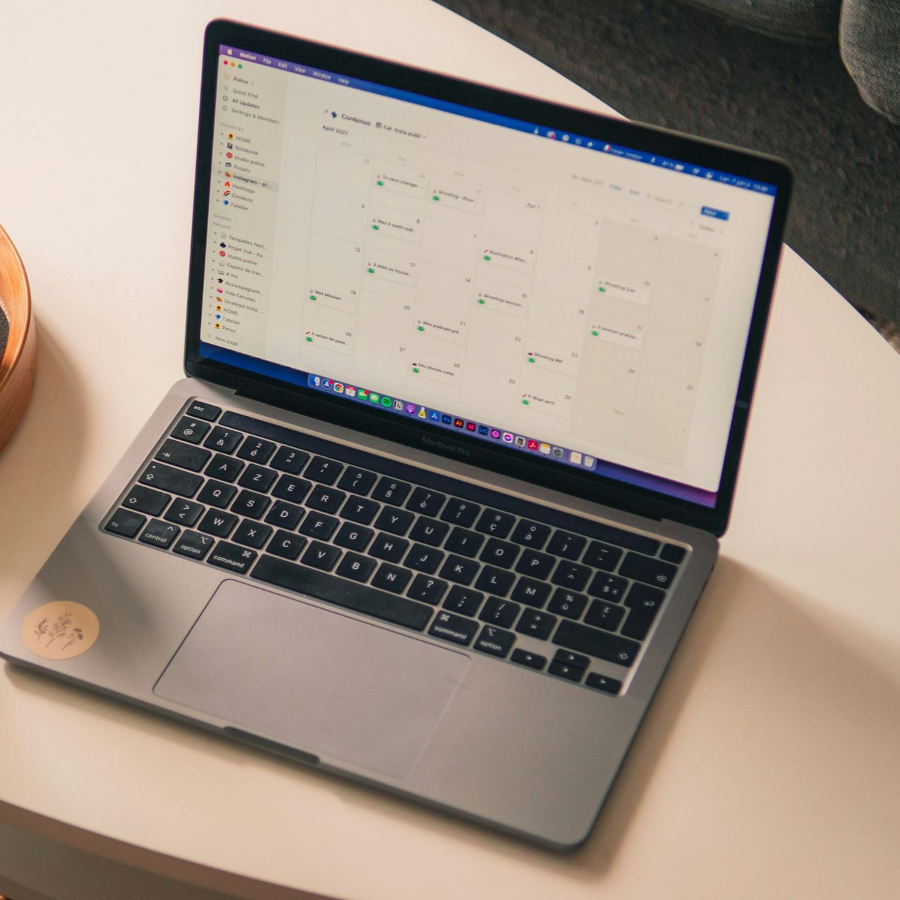 Laptop displaying a calendar app on a white table.