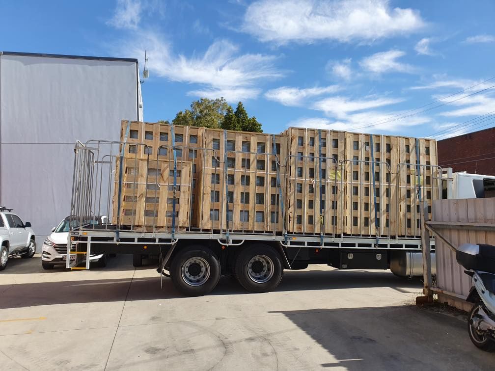 Truck is Loaded With Wooden Pallets in a Parking Lot — Pit Express in Tullamarine, VIC