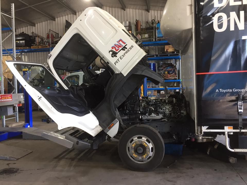 Truck With Its Hood Up is Being Worked on in a Garage — Pit Express in Laverton, VIC
