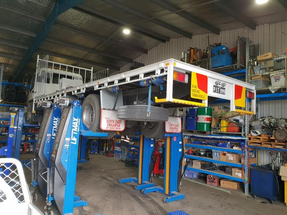 Truck is Sitting on a Lift in a Garage — Pit Express in Laverton, VIC