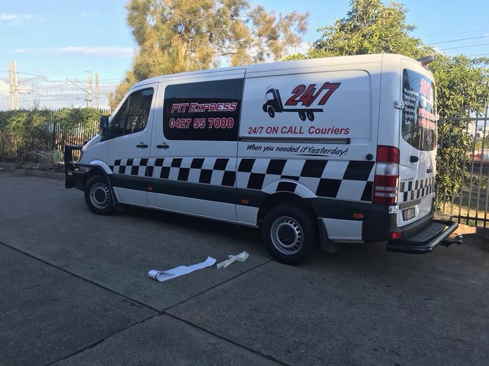 White Van With a Checkered Pattern is Parked on the Side of the Road — Pit Express in Muswellbrook, NSW