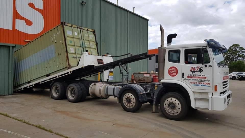 Truck is Towing a Shipping Container in a Parking Lot — Pit Express in Tamworth, NSW