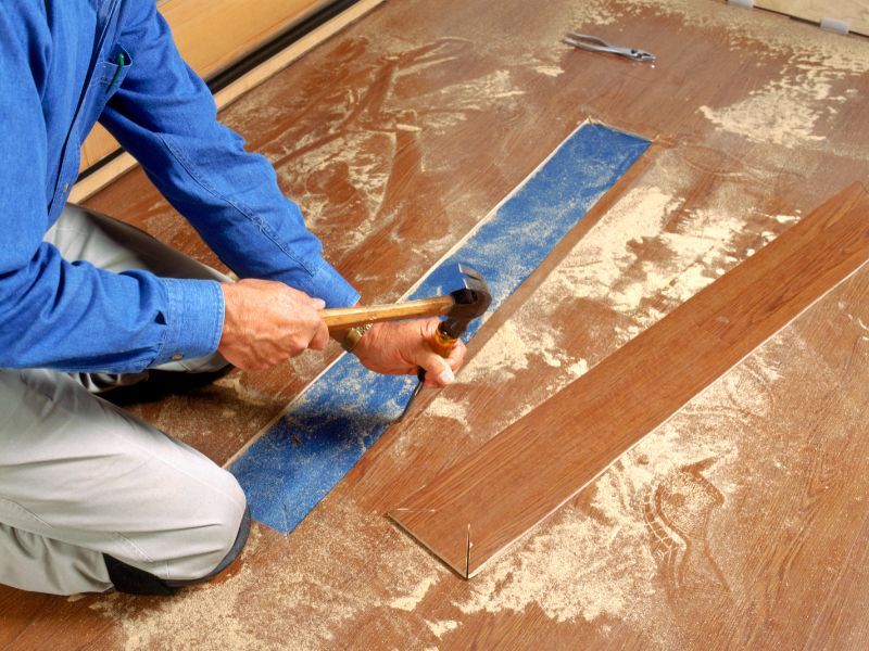Professional using tools to install hardwood flooring – Gulf of America Flooring, Spring Hill Florida.