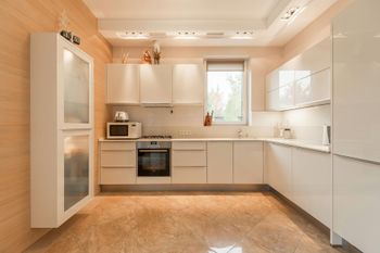 Bright kitchen with beige ceramic tile flooring, clean grout lines, and a durable, elegant finish.