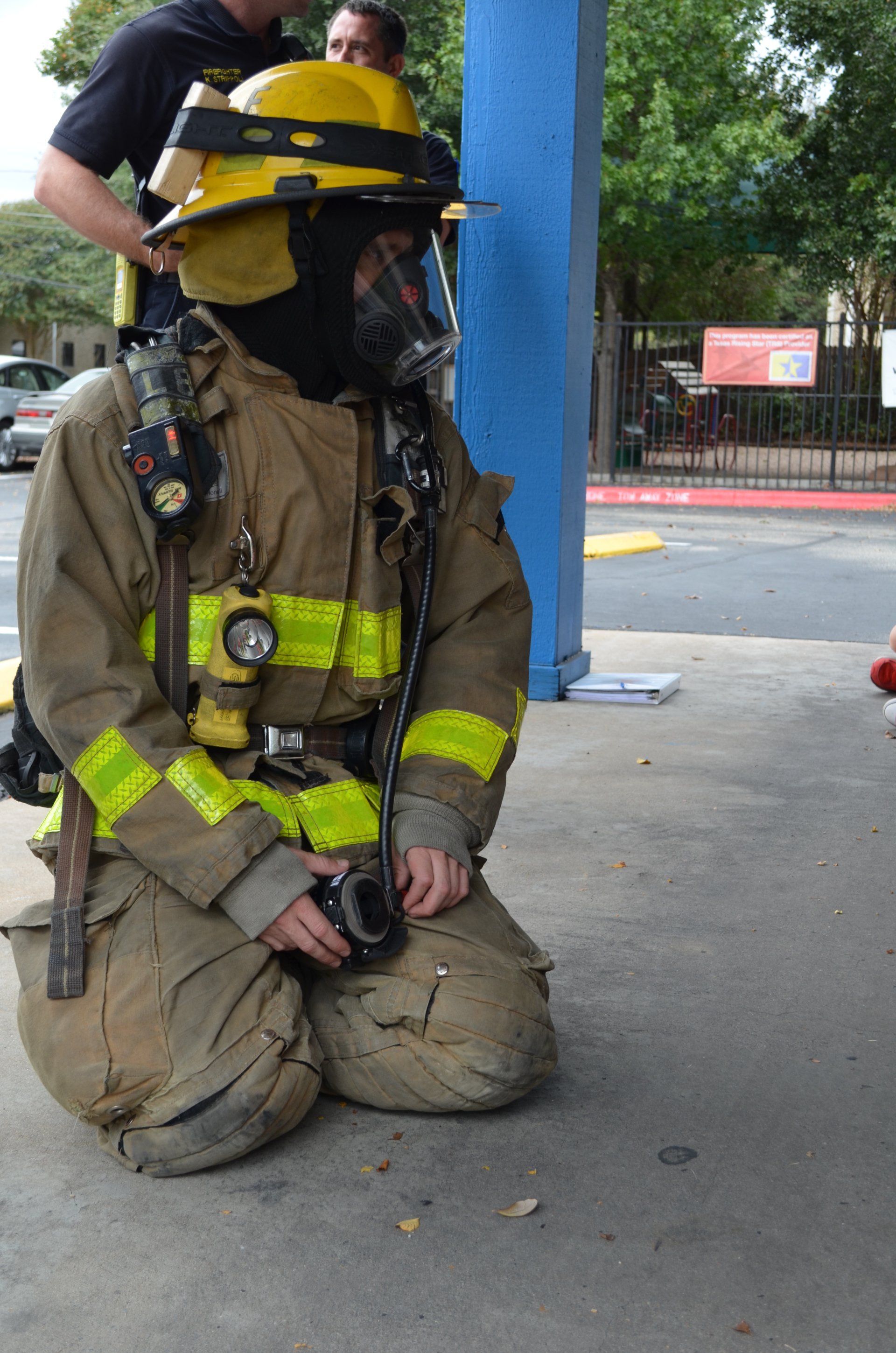 Fireman Kneeling — Austin, TX — Little Munchkins Learning Center