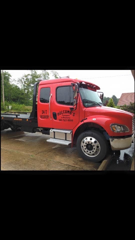 Red tow truck parked outdoors.