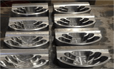 A bunch of metal pieces are sitting on top of each other on a table.