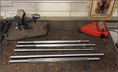 A bunch of metal rods on a table next to a budweiser sign