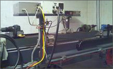 A bunch of wires are hanging from a wall in a room.