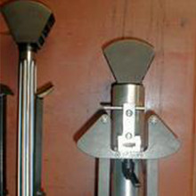 A close up of a microphone sitting on top of a wooden table.