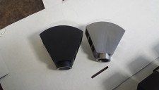 Two pieces of metal are sitting on top of a white surface.