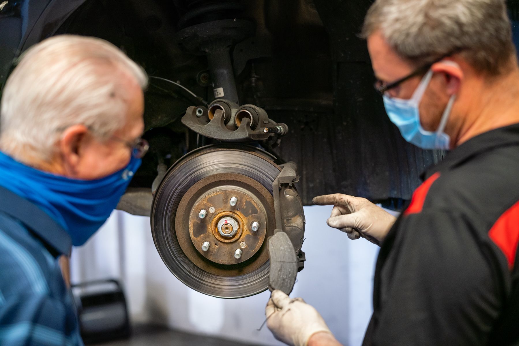 Two Technicians Checking Brake Pads And Rotor | Motorworks of Florida