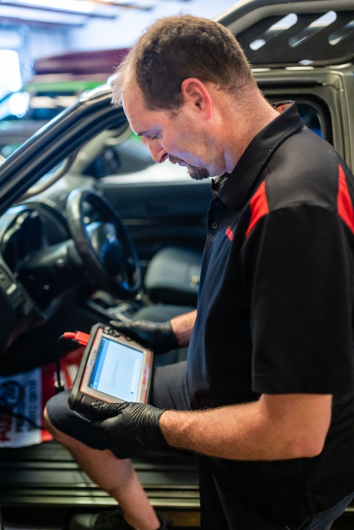 Technician Using Diagnostic Scanner Inside Vehicle | Motorworks of Florida