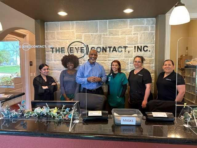 A group of people standing in front of a counter at the eye contact inc.