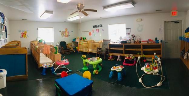 A room filled with lots of toys and a ceiling fan.