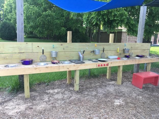 A wooden table with pots and pans on it