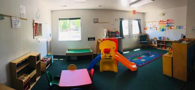 A playground with a table and chairs and a slide