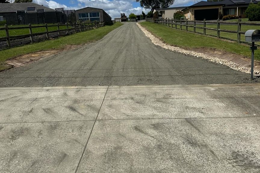 A white garage door is open in front of a house.