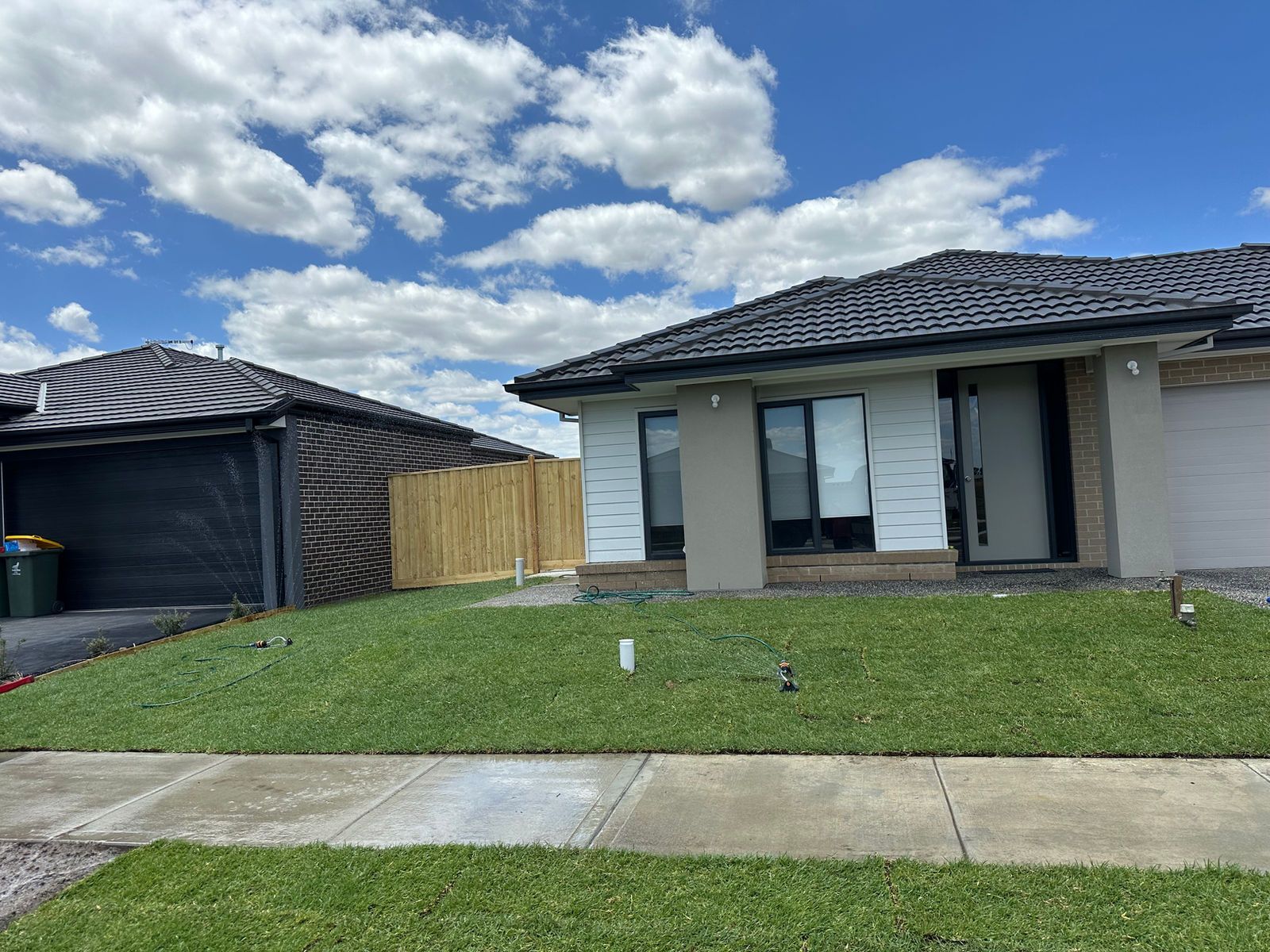 A house with a lot of grass in front of it.
