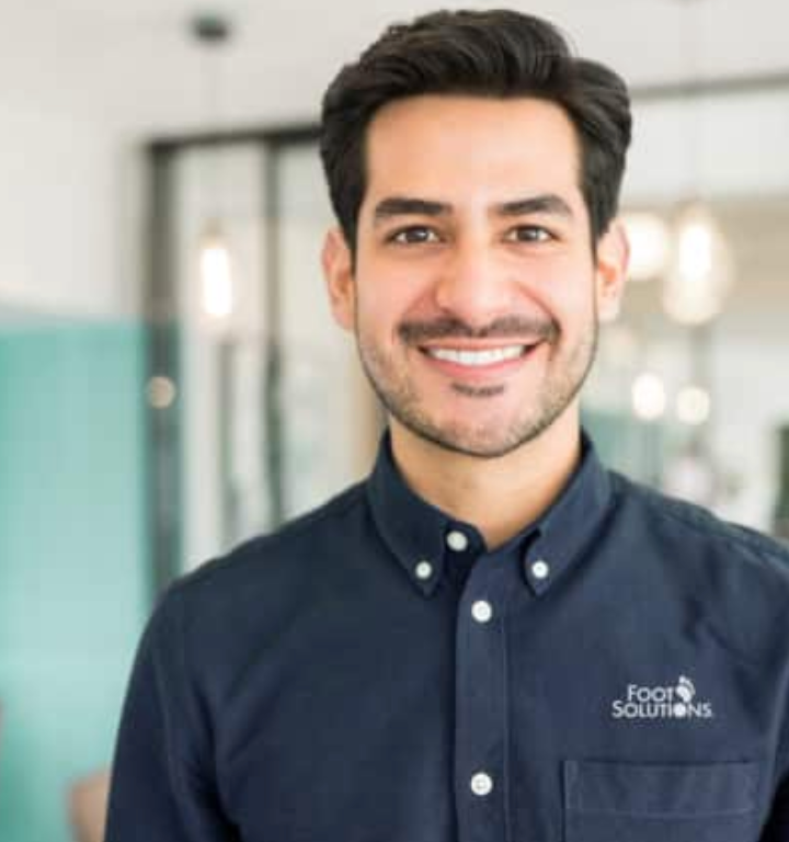 A man wearing a blue shirt that says food solutions