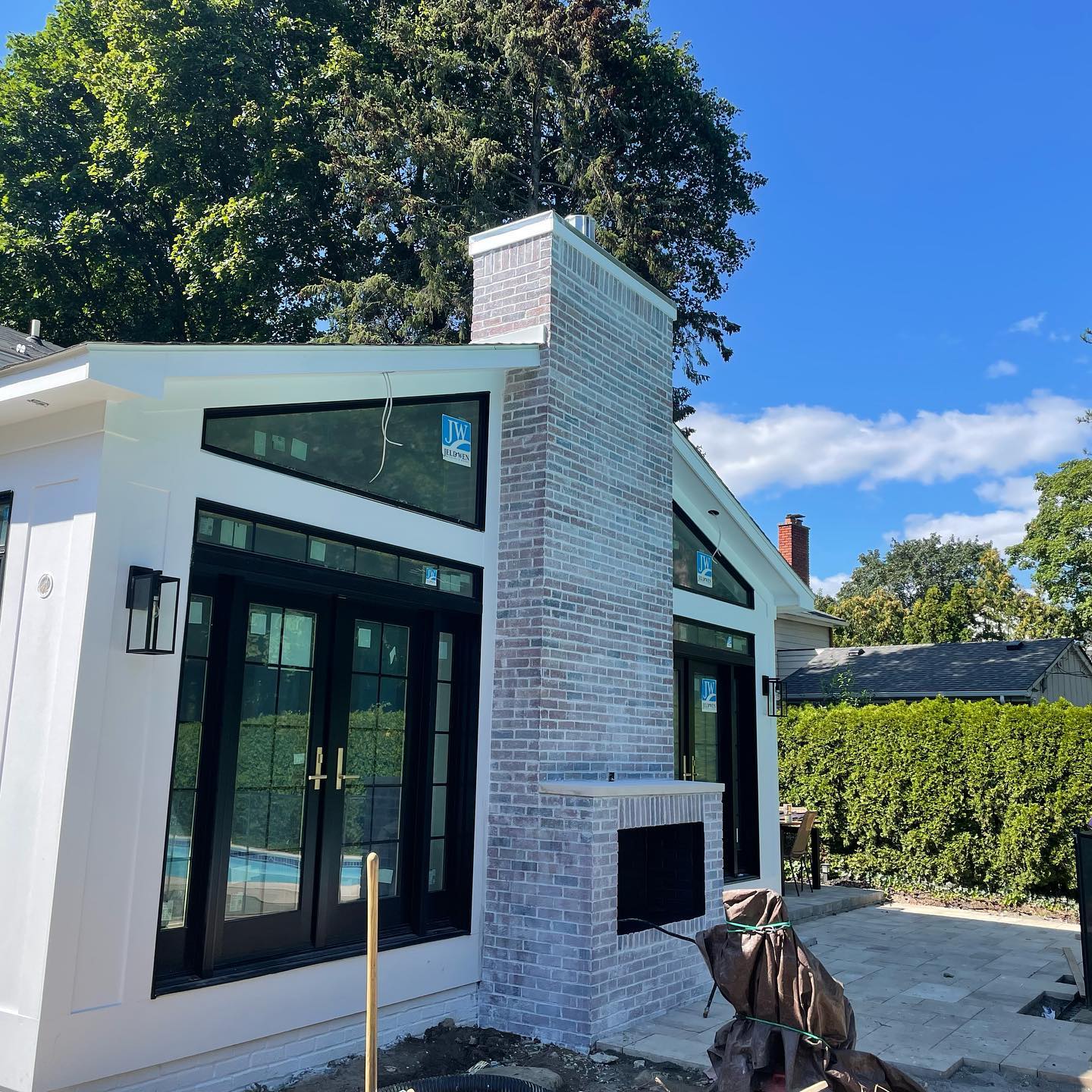 Residential home with white siding and black window trim painted by professionals