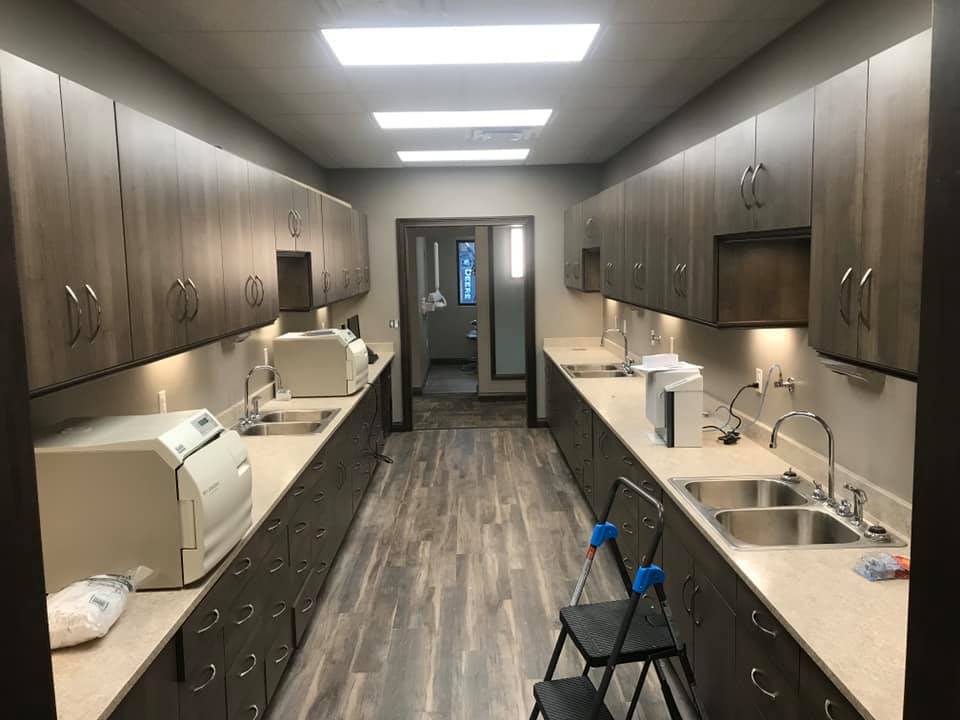 A dentist’s office with newly painted tan walls and newly installed cabinets
