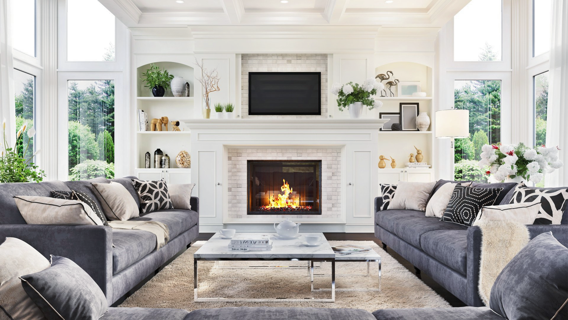 A re-painted white living room featuring a fireplace mantel and large windows