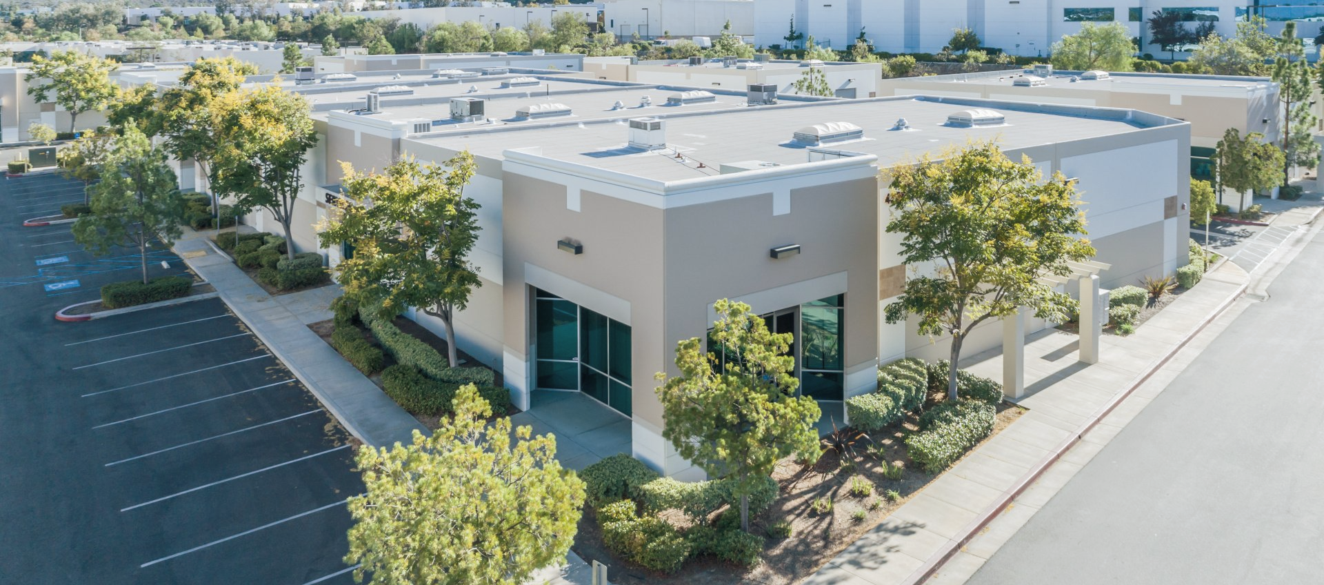 An office building painted tan and white by a commercial painting company