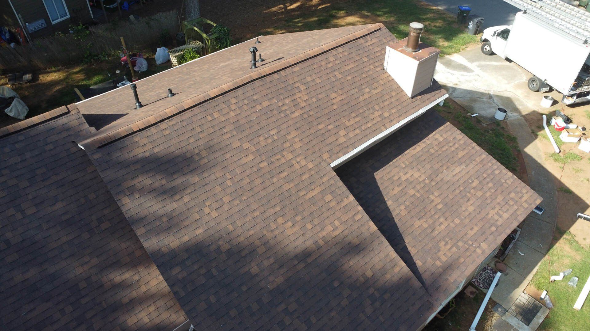 An aerial view of a roof of a house with a chimney.