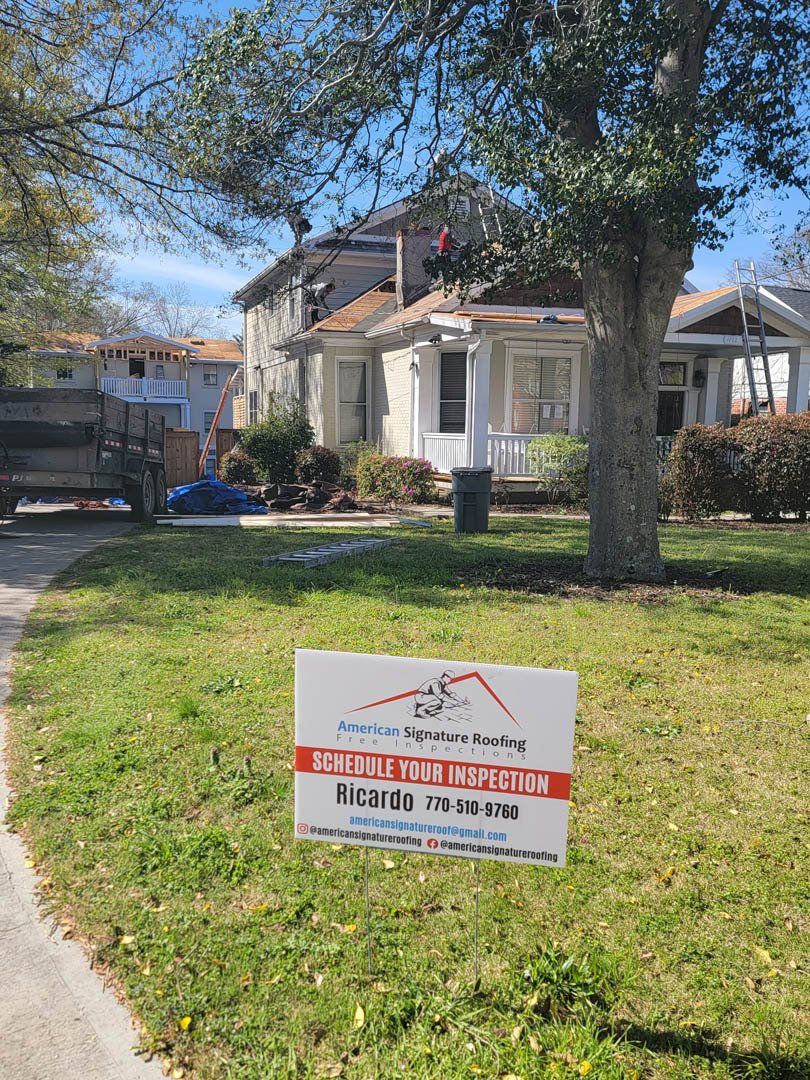 A white house with a sign in front of it.