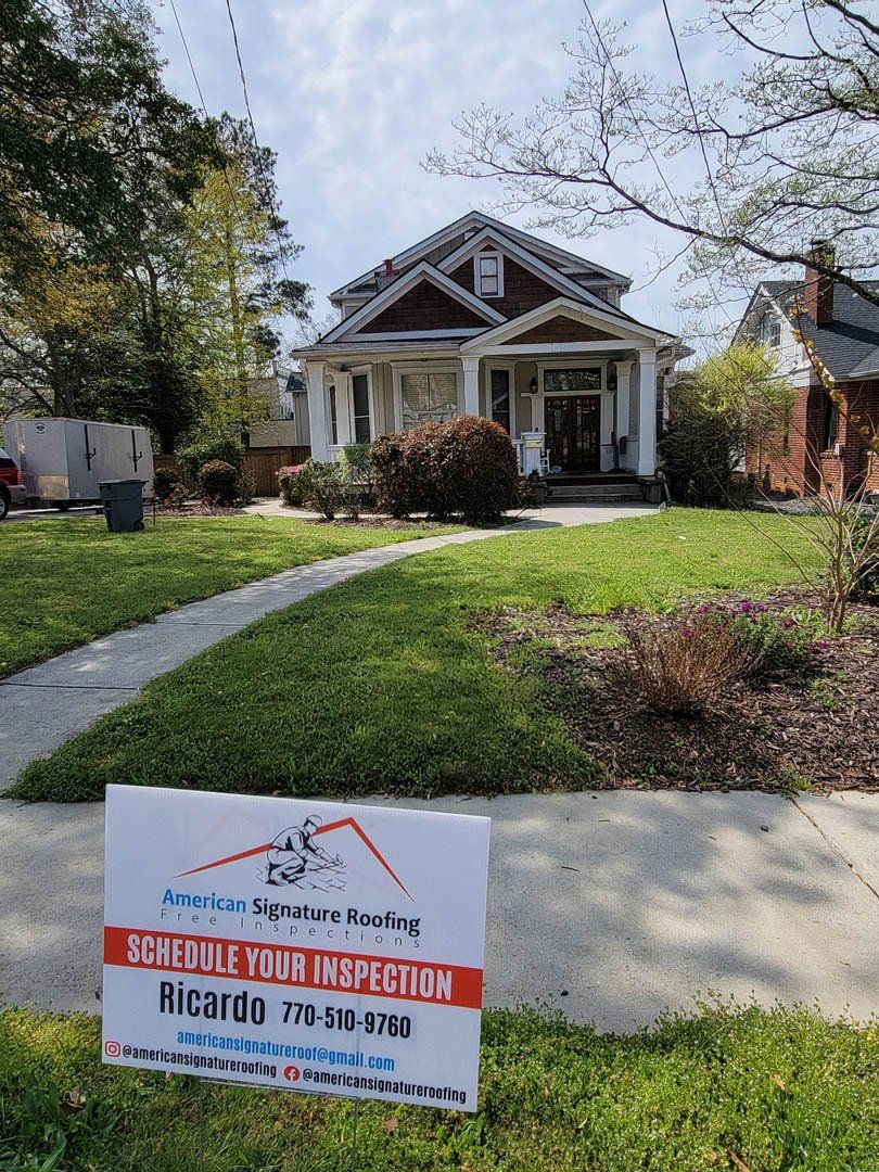 A house with a sign in front of it that says schedule your inspection.
