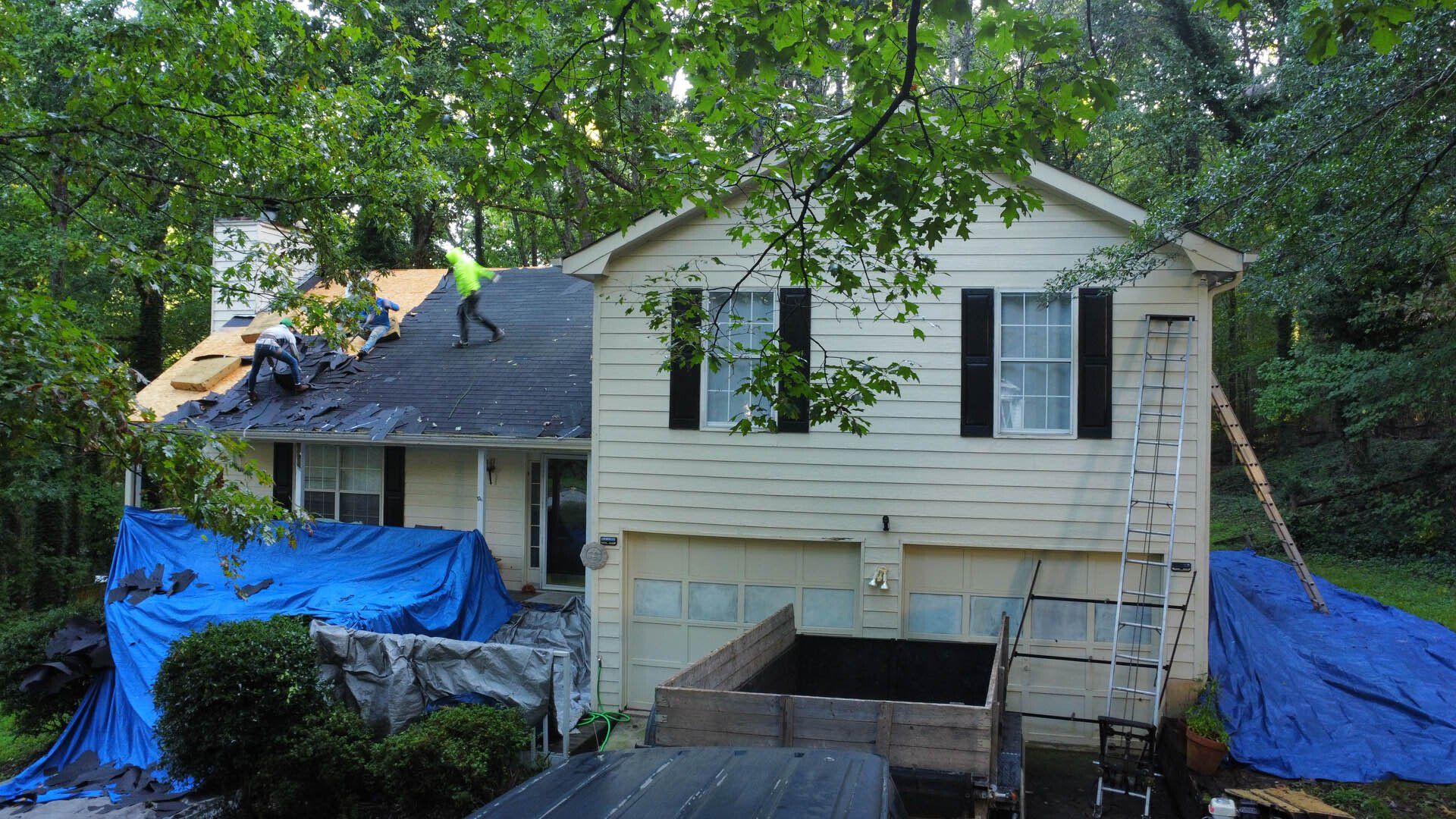 A man is working on the roof of a house.
