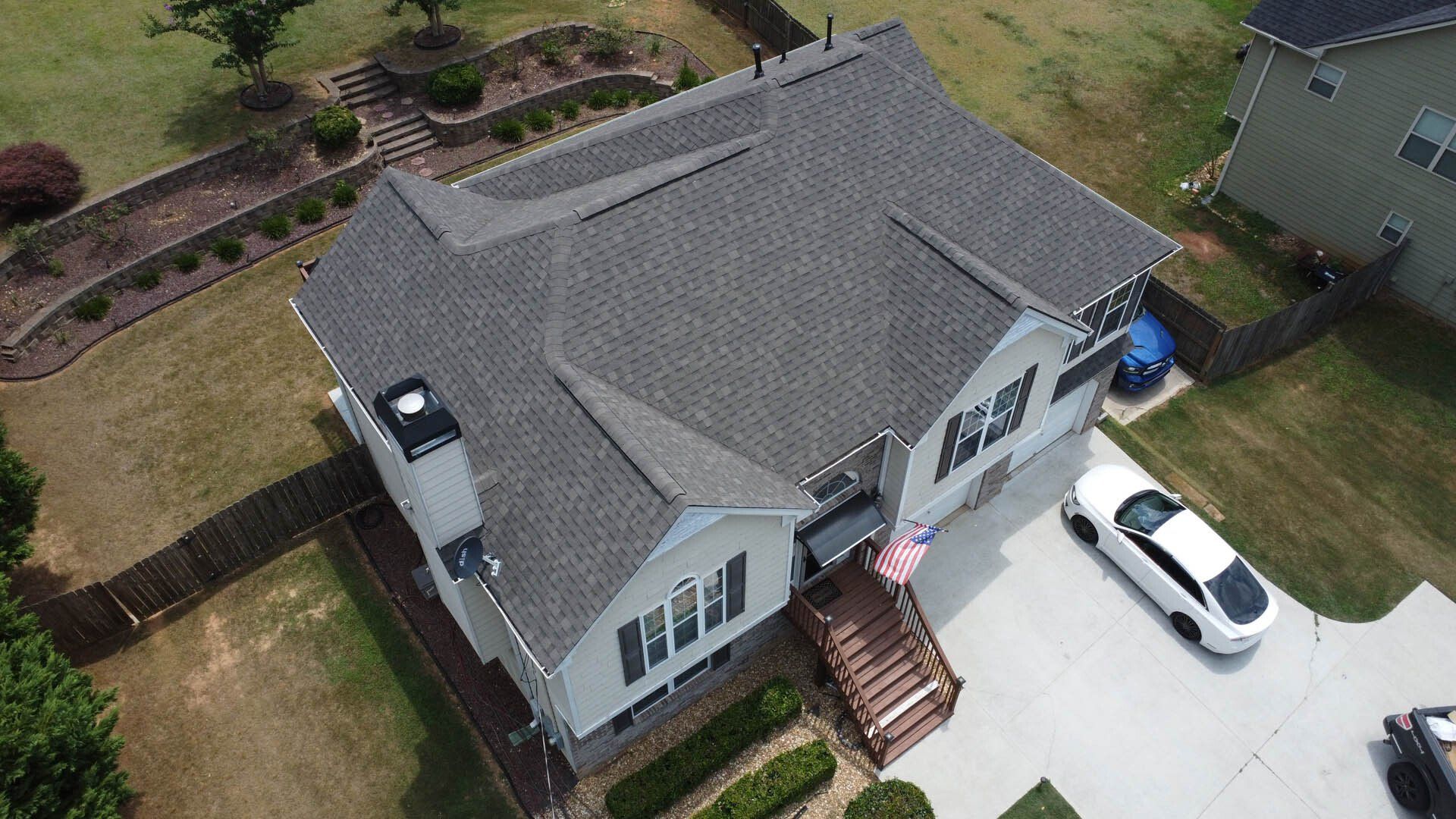 An aerial view of a house with a car parked in front of it.