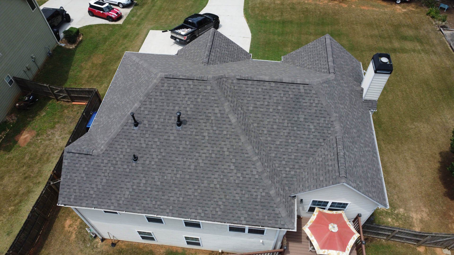 An aerial view of a large house with a gray roof.