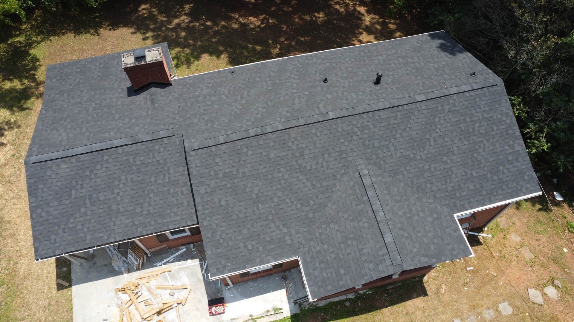 An aerial view of a house with a new roof.