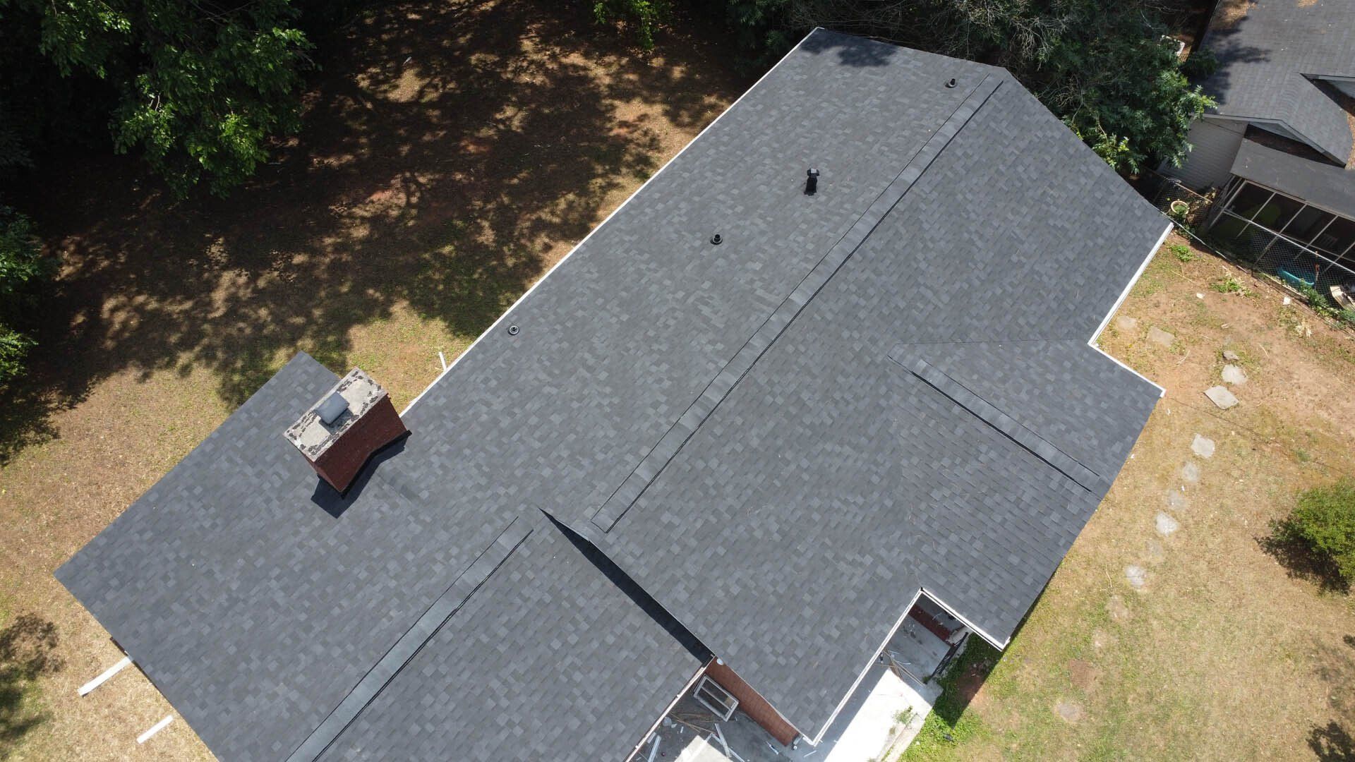 An aerial view of a house with a new roof.