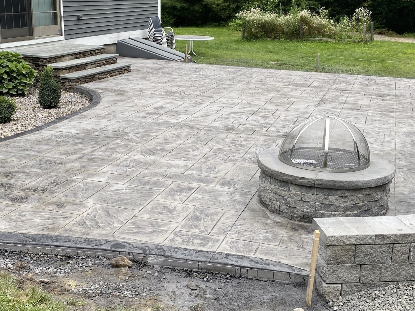 There is a fire pit in the middle of the patio.