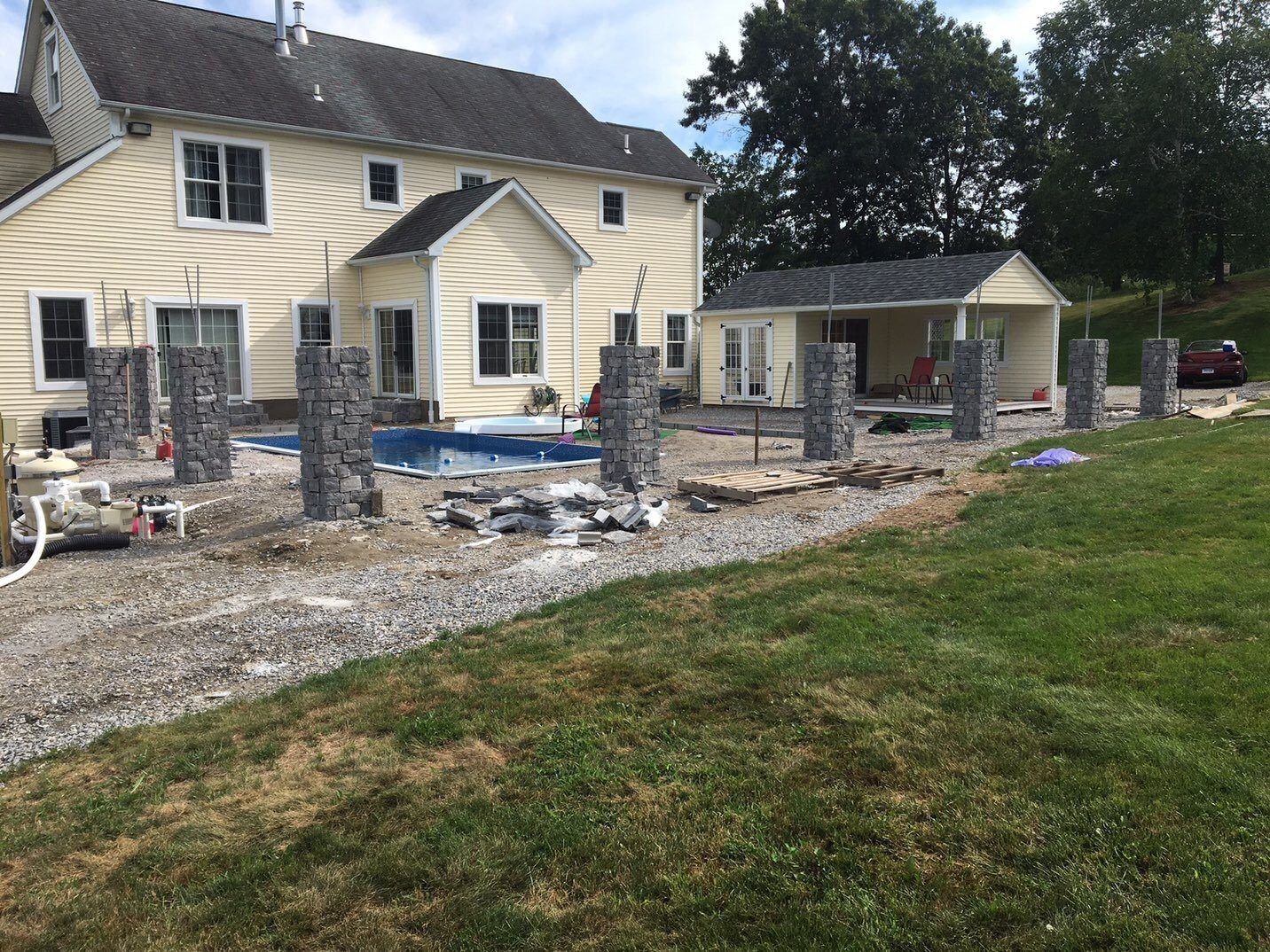 A house with a pool in the backyard is being built.
