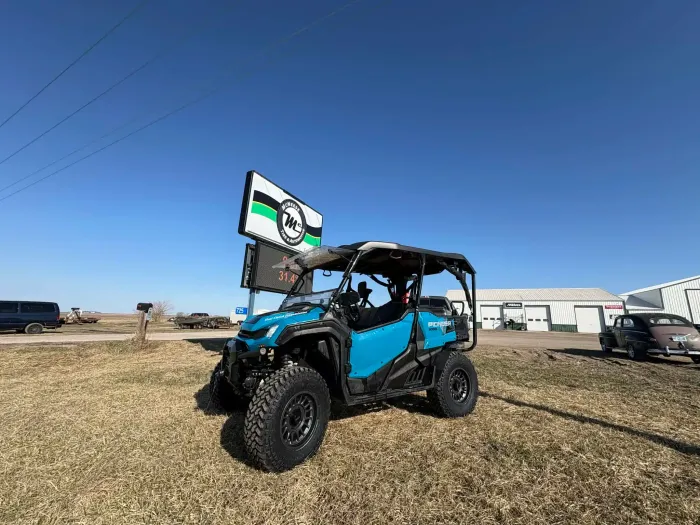 Off-road UTV parked next to a sign with McNeese Tirelogo | McNeese Tire L.C.
