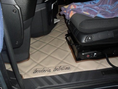 L'interno di un camion con un sedile e una coperta sopra