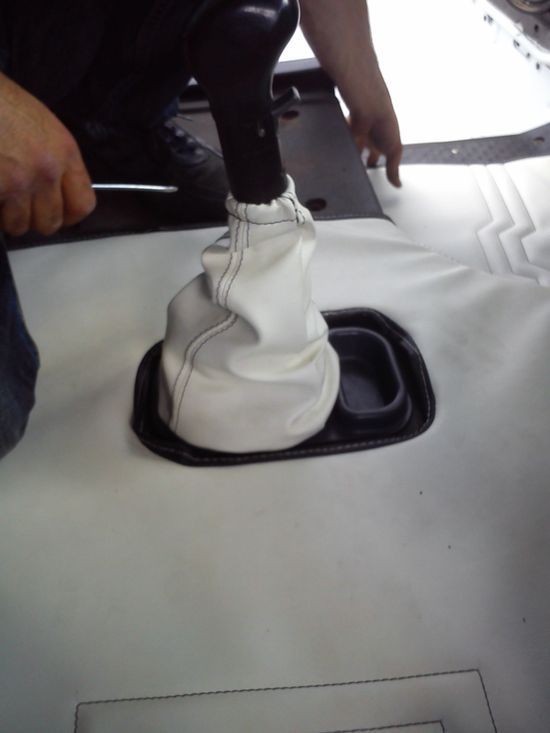 Una persona sta lavorando sul cambio di un'auto