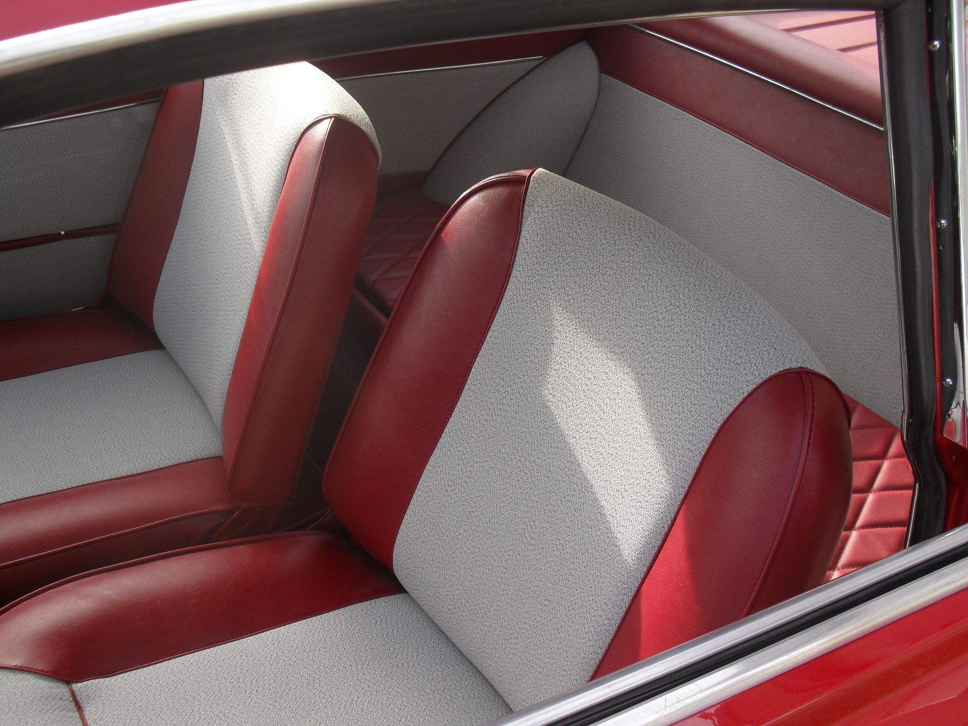 L'interno di un'auto rossa con sedili rossi e bianchi