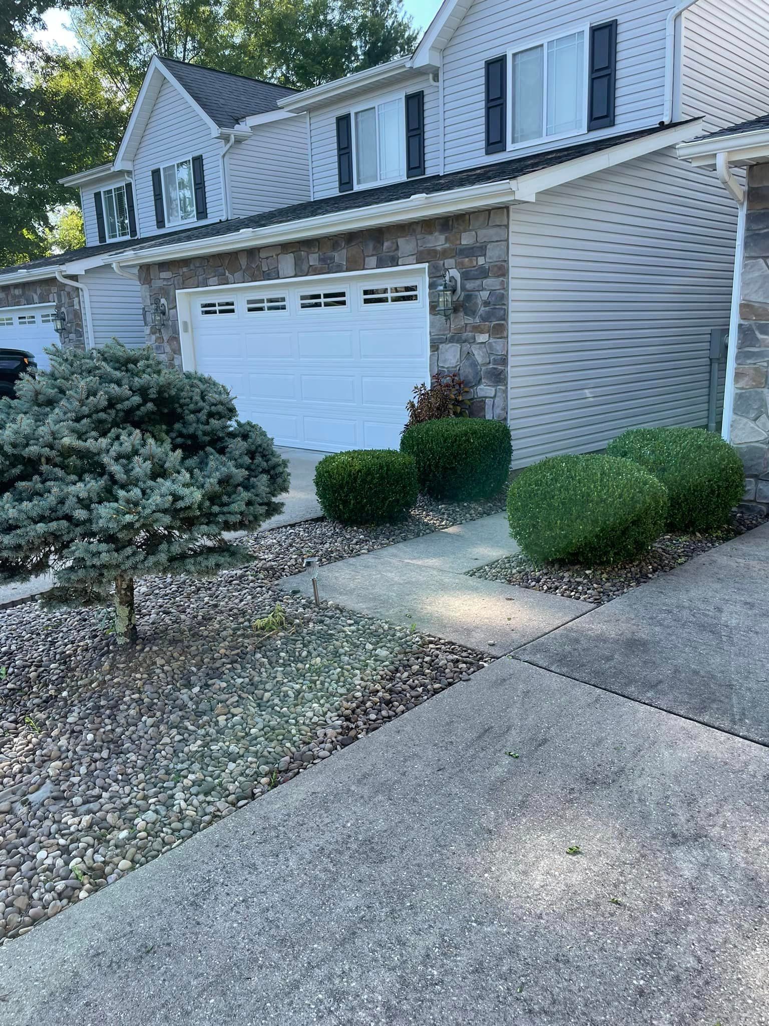 A House with a Garage Door and a Driveway in Front of It | Putnam County, WV | Jones Empire Tree Service