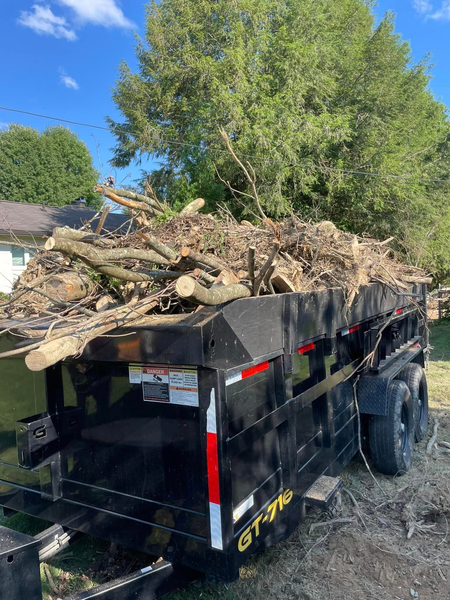 A Dumpster Trailer Filled with a Pile of Wood | Putnam County, WV | Jones Empire Tree Service