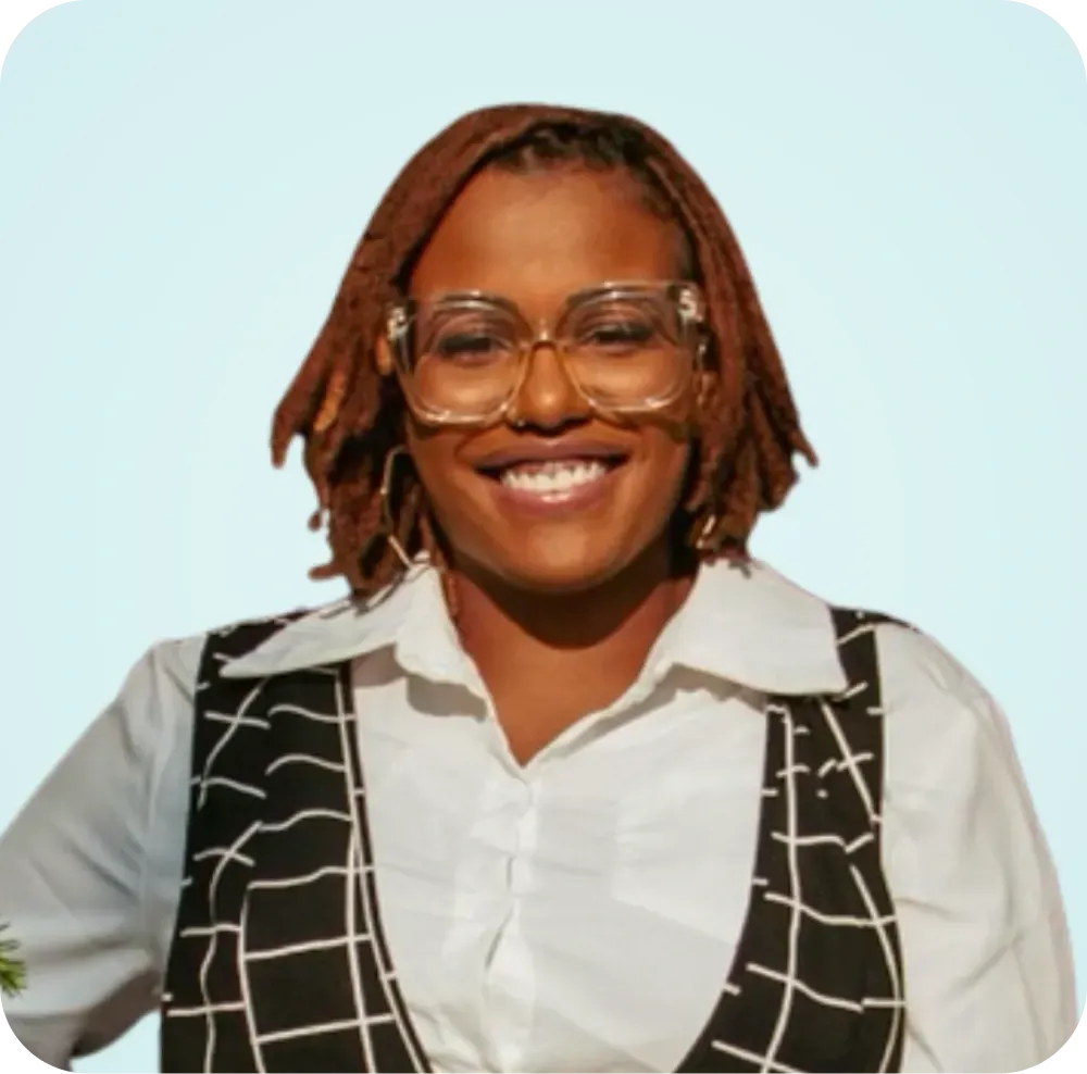 A woman wearing glasses and a white shirt is smiling